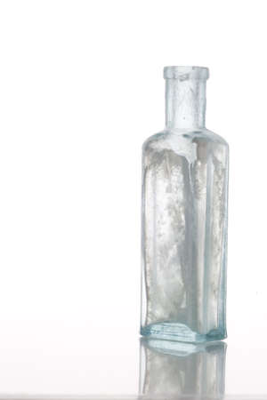 Antique  bottle on white table  Professionally spotted and retouched.の写真素材