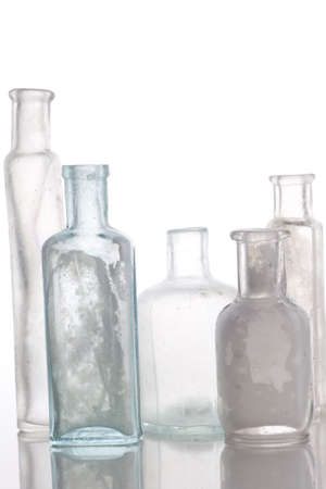 Antique bottles on white table  Professionally spotted and retouched.の写真素材