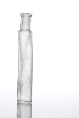 Antique bottle on white table with isolated backgroundの写真素材