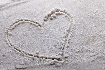 heart drawn in sand with copy spaceの写真素材