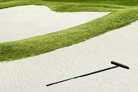 sand trap and green grass on golf courseの写真素材