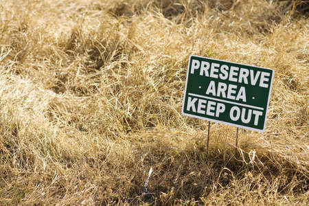 keep out sign in brown grass preserve areaの写真素材