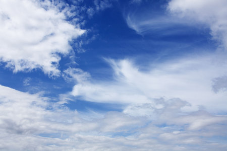 blue sky with white fluffy clouds background