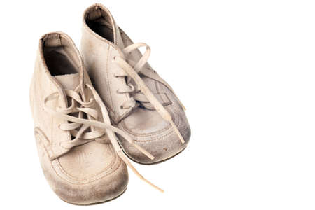 old baby shoes isolated on white backgroundの写真素材