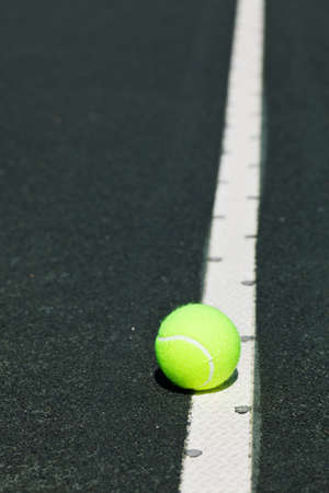 tennis ball on serve line of courtの写真素材