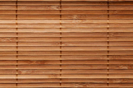 natural bamboo slatted mat background in brown tonesの写真素材