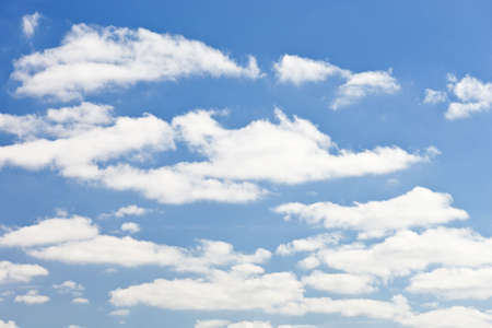 blue sky with white fluffy clouds backgroundの写真素材