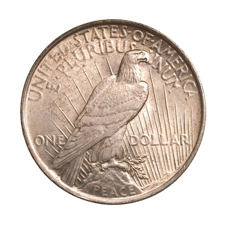 antique silver dollar isolated on white backgroundの写真素材