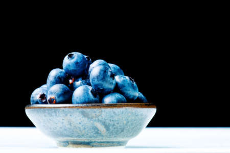 blueberries in a Japanese raku bowlの写真素材