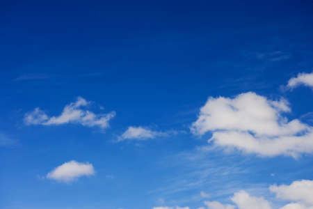 blue sky with white fluffy clouds backgroundの写真素材
