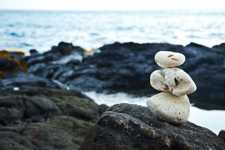 White Zen rocks on Hawaiian coastline with lavaの写真素材