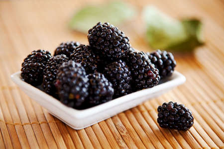 blackberries isolated on a bamboo mat backgroundの写真素材