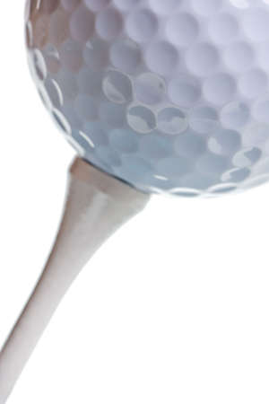 golf ball on tee isolated on whiteの写真素材