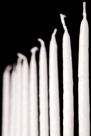 white hanukkah candles on a black backgroundの写真素材