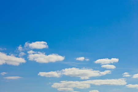 blue sky with white fluffy clouds backgroundの写真素材