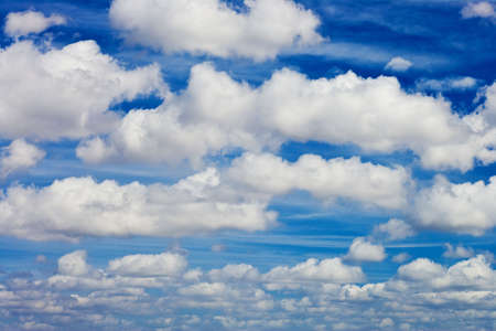 blue sky with white fluffy clouds backgroundの写真素材