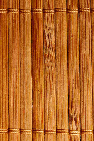 natural bamboo slatted mat background in brown tonesの写真素材