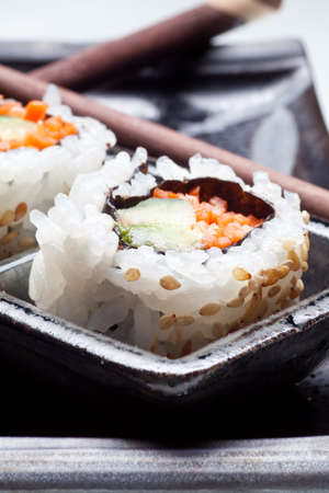 Vegetarian sushi California roll with rice and seaweed on Japanese platesの写真素材