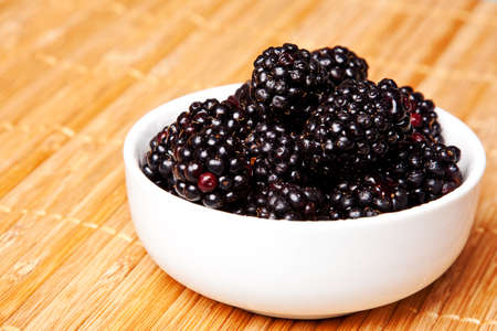 blackberries isolated on a bamboo mat backgroundの写真素材