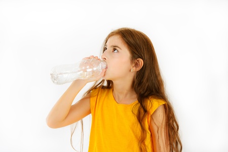 Beautiful girl drinking water isolated on white backgroundの写真素材
