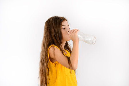 Beautiful girl drinking water isolated on white background