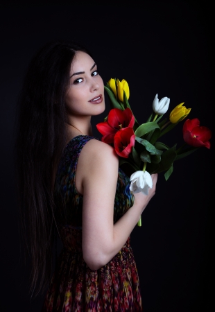 Beautiful young girl with a bouquet of flowers の写真素材