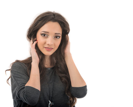 beautiful young woman posing in studio on white background