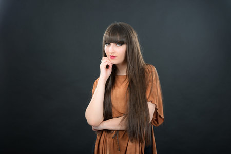 studio portrait of attractive young woman with long hairの写真素材