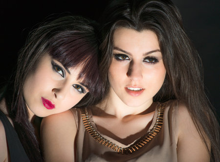 Two charming girls on a black background