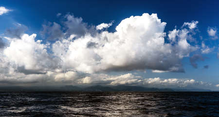 landscape with beautiful clouds over the oceanの写真素材