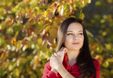 Young woman in a romantic autumn sceneryの写真素材