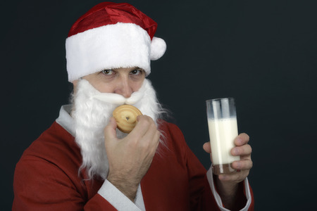 Portrait of Santa Claus Drinking milk from glass and  cookiesの写真素材