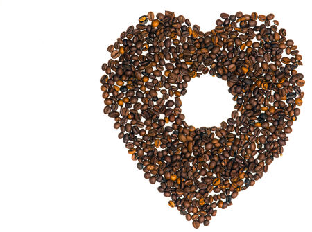 Heart from coffee beans with a hole in the middleの写真素材