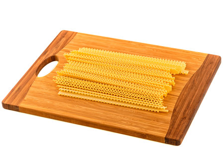 uncooked homemade egg pasta on a cutting boardの写真素材