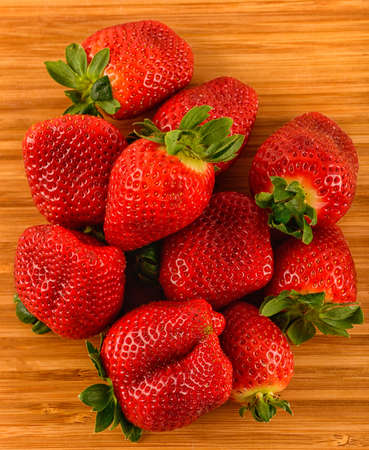 ,group of strawberries over a piece of old wood,の写真素材