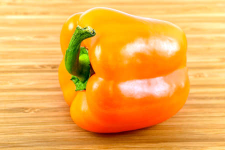 Orange Bell Pepper on woodの写真素材