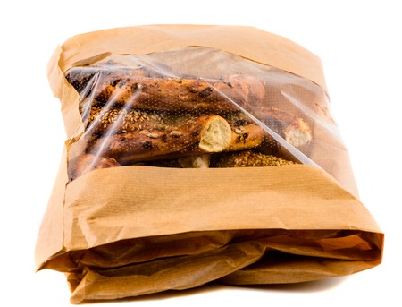 Closeup of three bagels in a brown paper bagの写真素材