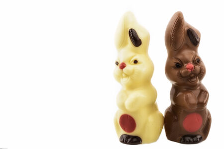 Two chocolate bunnies on a white backgroundの写真素材