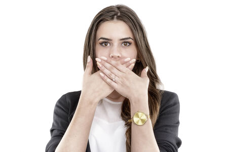 Portrait of happy smiling young business woman covering with handの写真素材