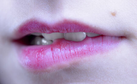 Biting her red lips teethの写真素材