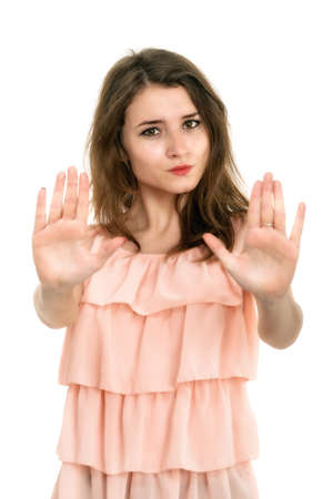Lady making stop gesture with her palm, isolated on whiteの写真素材