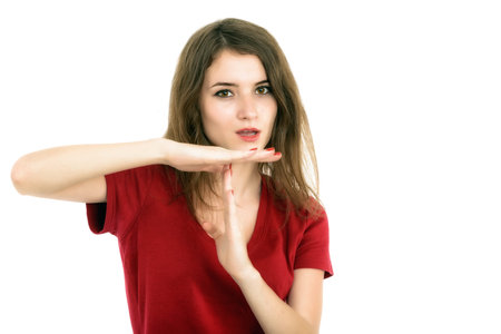 Girl showing time out sign isolated on white