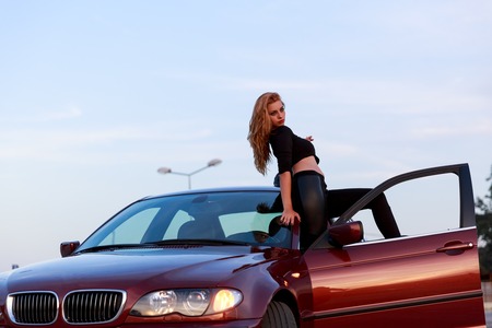 Young pretty lady with a clasic carの写真素材