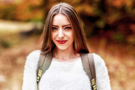 young brunette woman portrait in autumn colorの写真素材