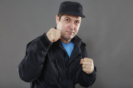 Security guard attack position isolated on gray background