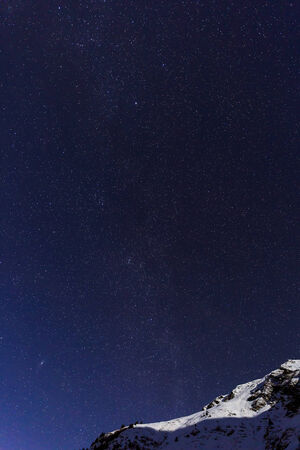 landscape with mountains and blue sky in winter nightの写真素材