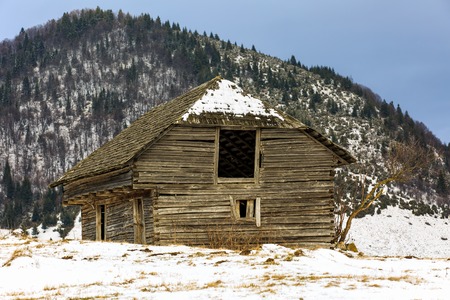 Old wooden barn in the countryside, in the winterの写真素材