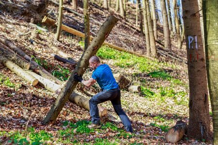 strong man carrying a tree trunkの写真素材