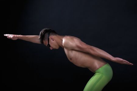 Profile of young , caucasian athlete swimmer with goggles in start positionの写真素材