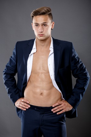 young businessman isolated on gryの写真素材